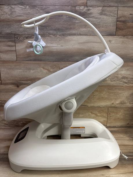 Side view of Graco Smart Sense Soothing Baby Swing Rori showcasing a reclined seat and toy bar on wood plank background
