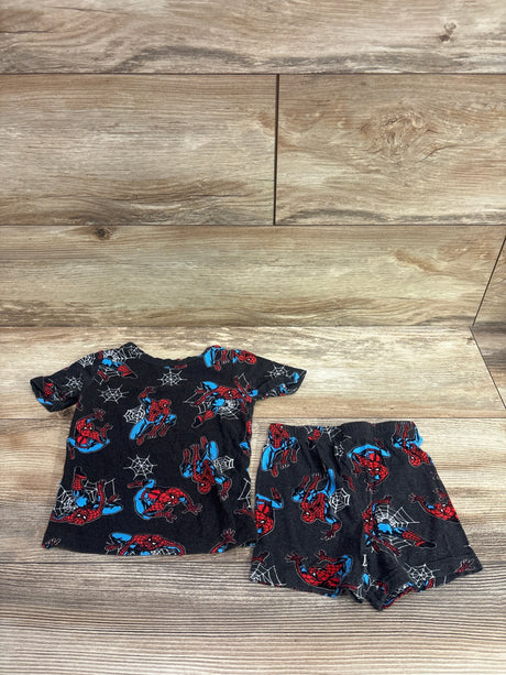 Flat lay of Marvel Spider-Man 2pc pajama set in grey, showing short-sleeve top and shorts with Spider-Man print on wood floor