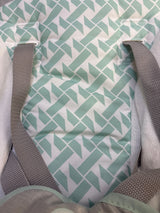 Close-up of Ingenuity Keep Cozy 3-in-1 bouncer seat insert showing mint geometric liner, gray harness straps and white plush side padding