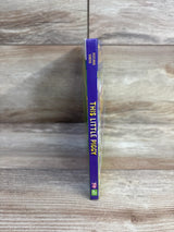 Spine view of This Little Piggy board book showing purple spine with vertical title and small pig icon on wood background