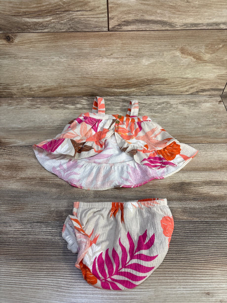 Flat lay of Carter's 2-piece floral tank and bloomers in beige with pink leaf print, ruffle hem and elastic waist on wood