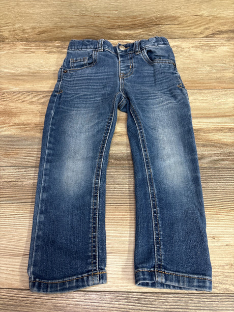 Front view of Cat & Jack slim blue jeans in size 3T showcasing belt loops, pockets, button closure, and cuffed hems on a wood background