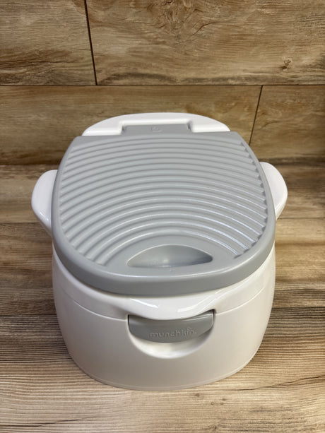 Front view of Munchkin Arm & Hammer Multi-Stage 3-in-1 Potty showcasing gray ribbed seat and white body on a wood-look floor