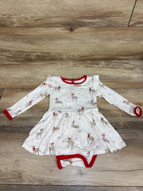 Top-down view of white Kyte Baby Bamboo Cloud Deer Twirl Bodysuit Dress with red trim, deer print, attached bodysuit, and wood background