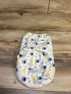 Top view of Petite L’amour plush swaddle wrap showcasing white plush fabric with giraffe, elephant, and bee print on a wood background