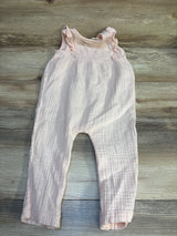 Light pink baby romper with ruffle sleeves on wood background, gently used kids clothing