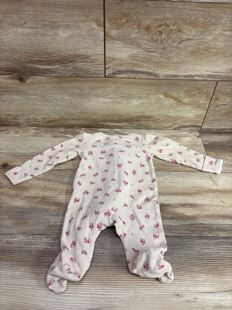 Carter's beige waffle knit baby sleeper with pink floral print on wood background