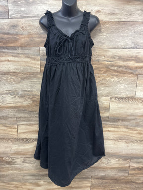 Front view of Old Navy black maternity sleeveless dress showcasing ruched straps and tie front with wood plank background