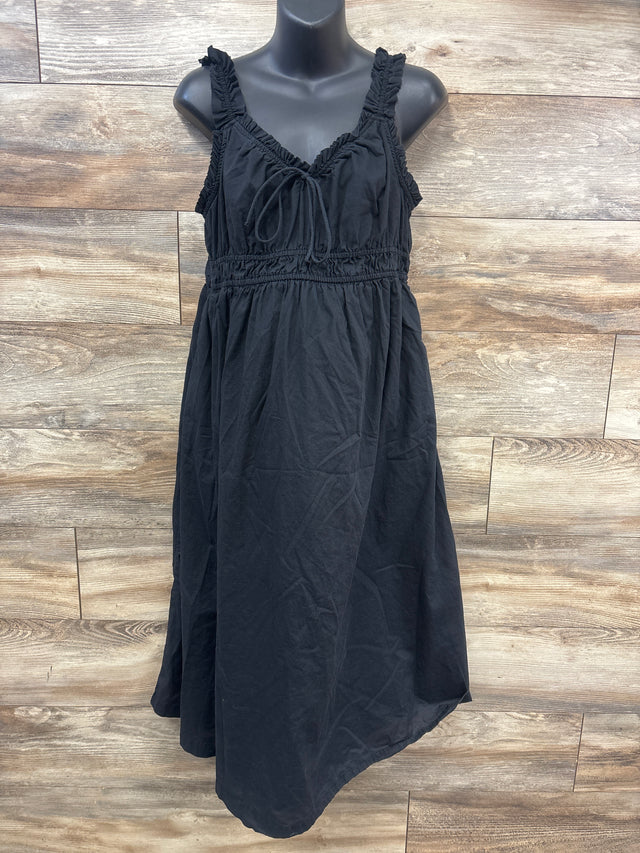 Front view of Old Navy black maternity sleeveless dress showcasing ruched straps and tie front with wood plank background