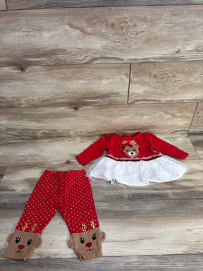 Red and white reindeer baby outfit set with tutu top and polka dot leggings on wood floor