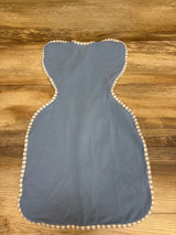 Top view of Love To Dream Swaddle Up stretch cotton swaddle in blue, size small newborn, showcasing striped trim on a wood surface