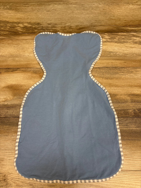 Top view of Love To Dream Swaddle Up stretch cotton swaddle in blue, size small newborn, showcasing striped trim on a wood surface
