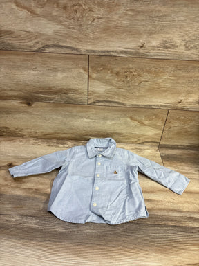Baby Gap light blue button-up shirt for infants size 12-18 months on a wooden background