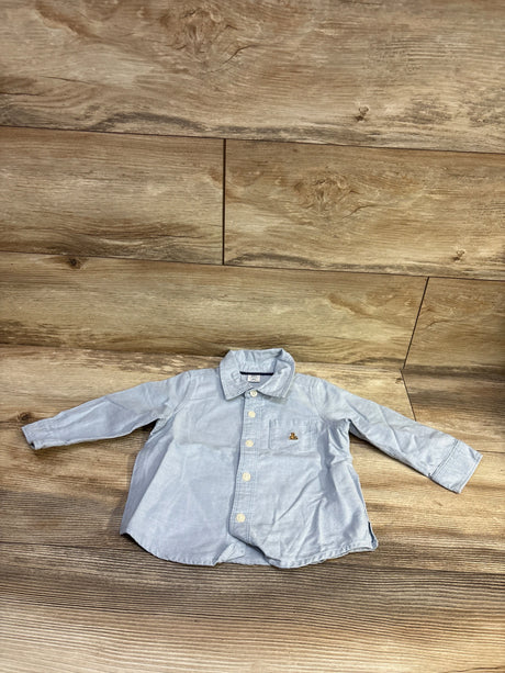 Baby Gap light blue button-up shirt for infants size 12-18 months on a wooden background