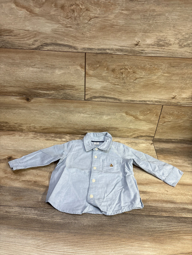 Baby Gap light blue button-up shirt for infants size 12-18 months on a wooden background