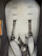 Gray padded baby stroller seat with adjustable safety straps and harness