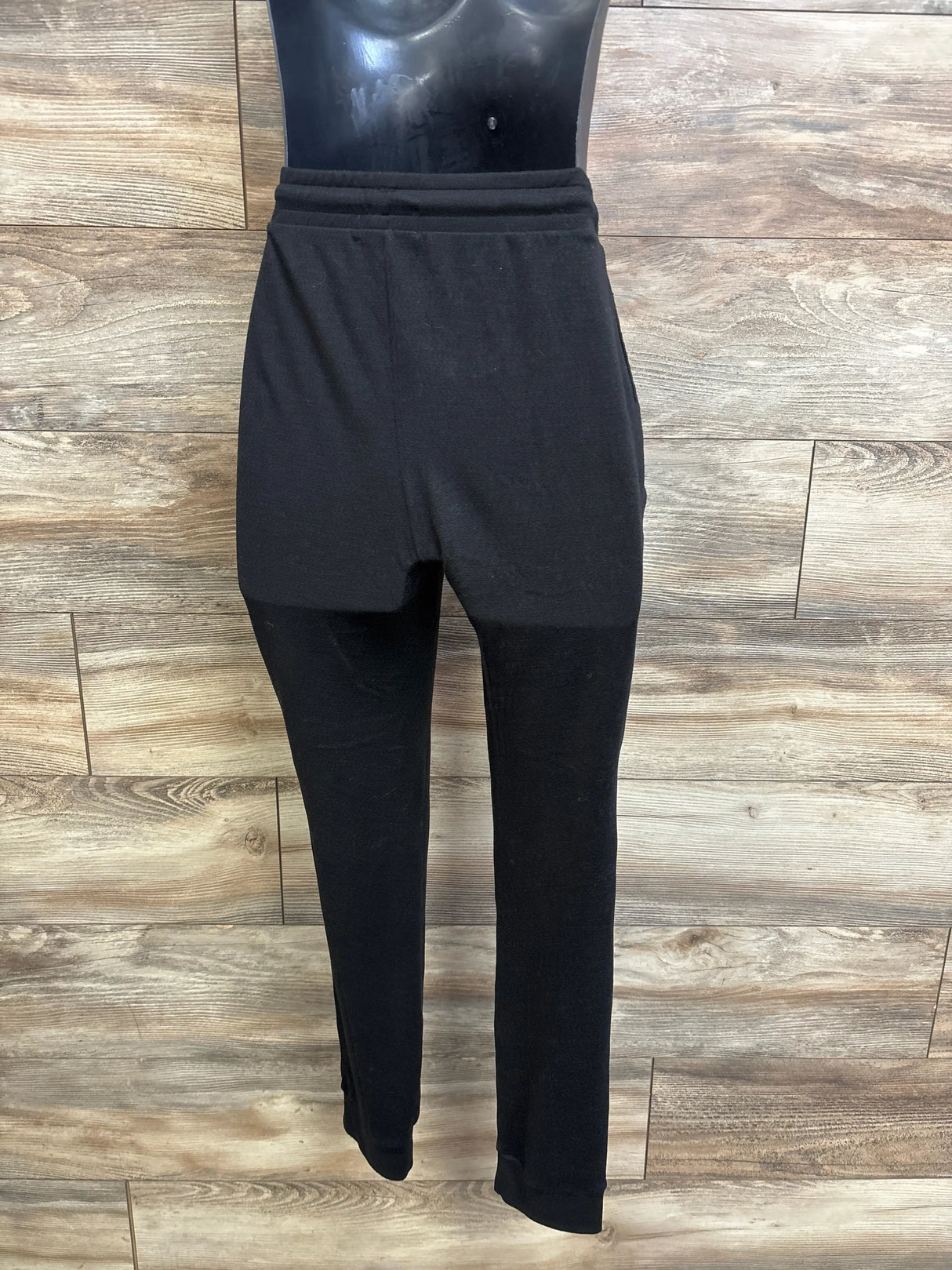 Front view of Feathers maternity joggers with high elastic waistband and cuffed tapered legs on wood background