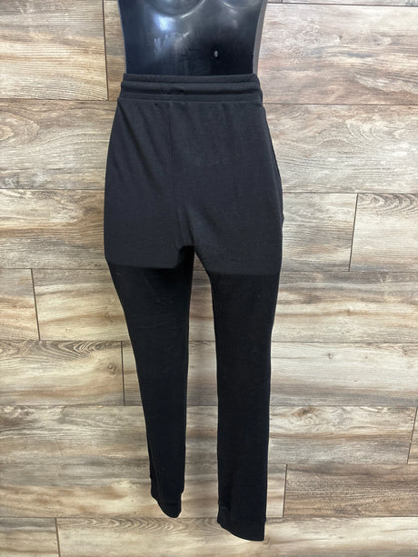 Front view of Feathers maternity joggers with high elastic waistband and cuffed tapered legs on wood background