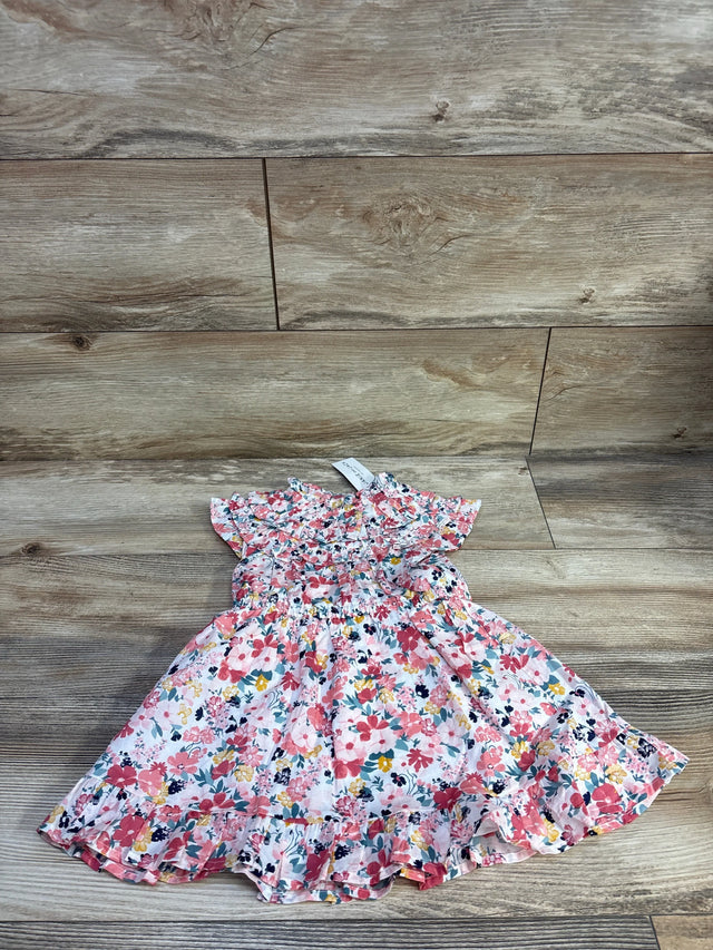 Flat lay of Janie and Jack pink floral toddler dress showcasing ruffle trim and smocked bodice with matching bloomers on wood floor