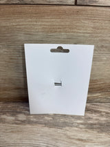 Front of 1st birthday hair bow display card (bow removed) showing hang slot and silver elastic loop on wood background