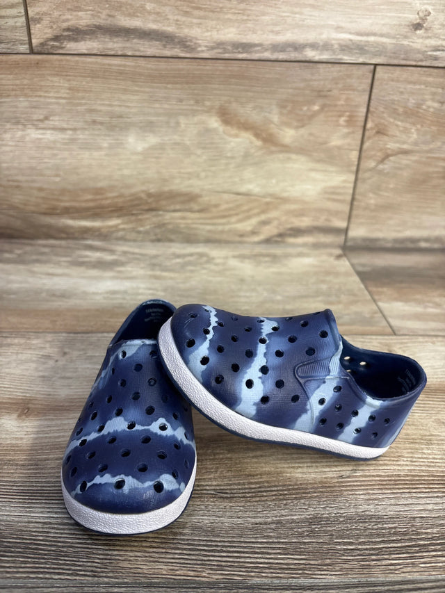 Three-quarter view of Cat and Jack slip-on toddler water shoes in navy tie-dye showing perforated upper and white sole on wooden floor
