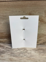 Front view of 2-pack brown hair bows backing card showing two silver alligator clips on light wood background