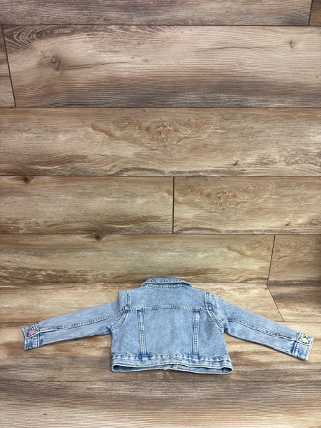 Old Navy blue denim jacket for toddlers size 2T laid flat on a wooden background