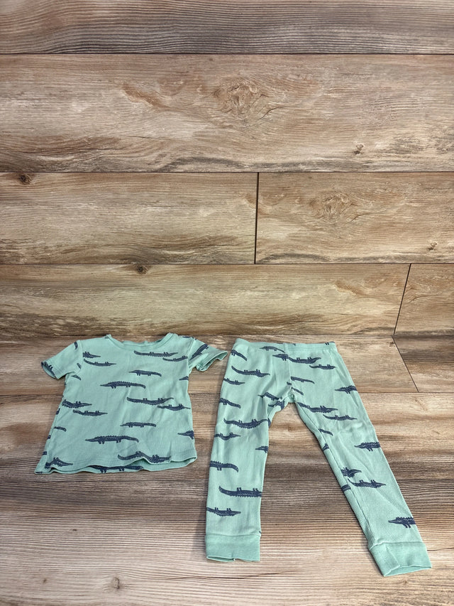 Flat lay of sage ribbed 2-piece toddler pajama set showing top and leggings with navy alligator print on wood floor