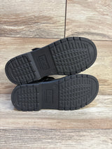 Bottom view of Children's Place black Mary Jane flats showing non-marking rubber soles with tread and 'PLACE' logo