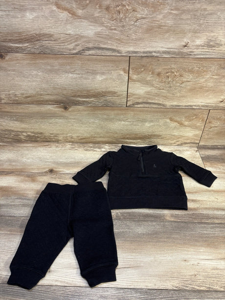 Flat lay of Baby Gap 2-piece quilted sweatshirt set size 3-6M showcasing half-zip top and matching quilted pants on wood floor