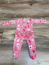 Front view of pink Siix reindeer zip footie sleeper with ruffled waist, long sleeves, and attached feet on wood
