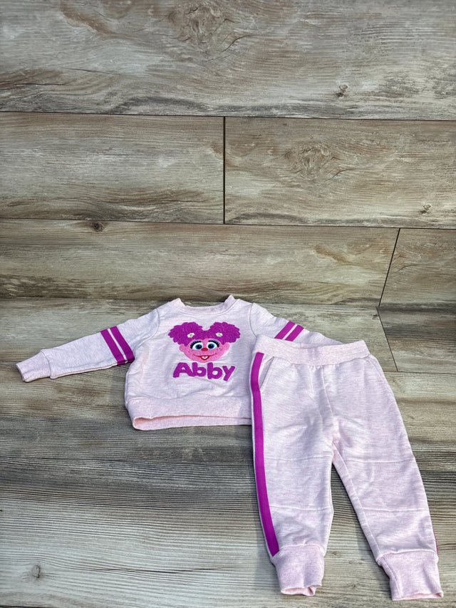 Pink toddler Abby sweatshirt and joggers set with purple accents on wood floor