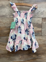 Girls pink and white sleeveless dress with Minnie Mouse print and ruffled straps on a hanger