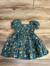 Green toddler dress with puff sleeves and floral print on wooden floor, kids clothing resale