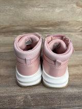 Pair of pink toddler high-top sneakers with white soles on wooden surface