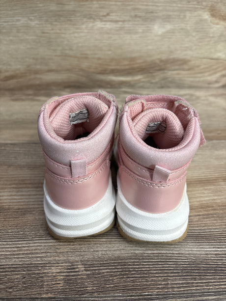 Pair of pink toddler high-top sneakers with white soles on wooden surface