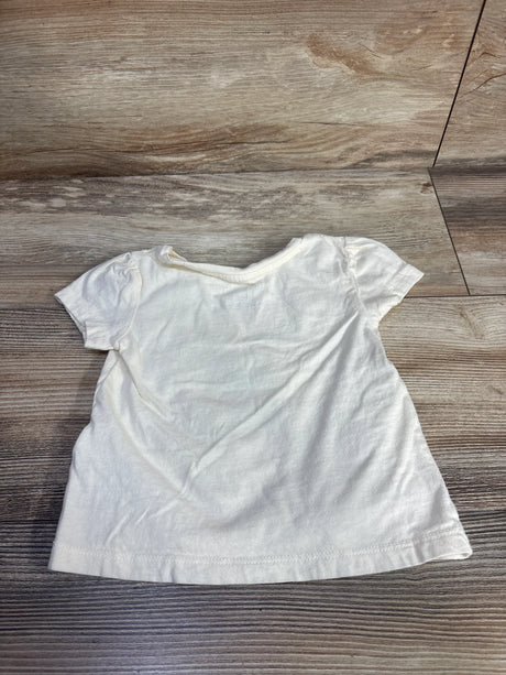 Back view of Baby Gap x Disney Minnie Mouse ivory toddler T-shirt showing puff sleeves and crew neck on wood floor