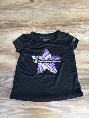 Black Champion kids' tee with purple star graphic, size 4T, laid on wood floor