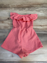 Pink ruffle off-shoulder toddler romper on wooden background, children's clothing