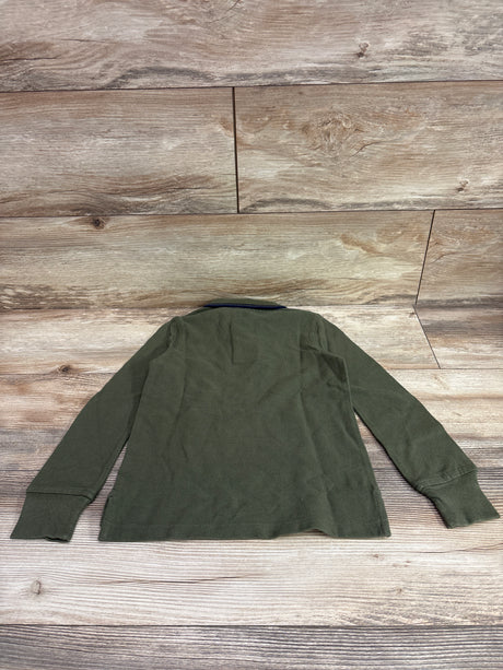 Back view of Baby Gap green long sleeve polo shirt in size 4/5T showcasing collar and cuffs on a wood background