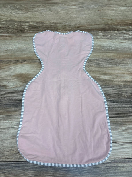 Top view of a pink Love To Dream Swaddle Up Stretch Cotton swaddle sack showcasing striped trim on a wood-grain surface