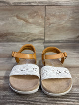 Front view of Cat & Jack toddler Blair strap footbed sandals showcasing tan ankle straps and white crocheted toe bands on wood floor background
