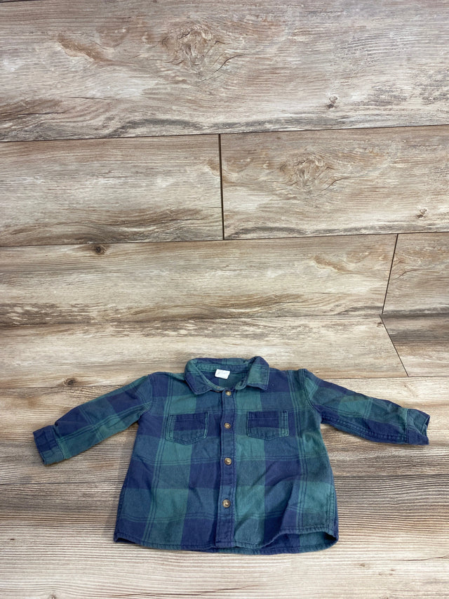 Toddler-sized blue and green plaid long-sleeve button-up shirt laid flat on wood floor