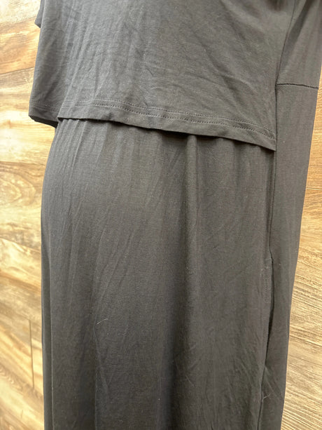Close-up of black Smallshow maternity nursing dress showcasing layered nursing panel against wood flooring