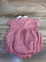 Top-down view of red gingham baby bubble romper with white scalloped Peter Pan collar, back buttons, and elastic leg openings on wood background