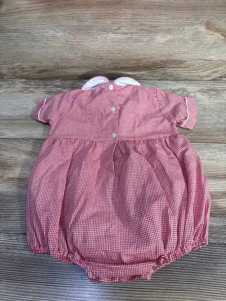 Top-down view of red gingham baby bubble romper with white scalloped Peter Pan collar, back buttons, and elastic leg openings on wood background