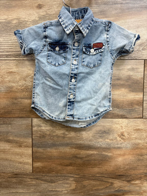 Front view of 7 For All Mankind denim button-down shirt, size 12M, showing chest pockets and faded blue wash on wood floor