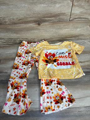 Girls' Thanksgiving turkey print outfit with yellow top and festive patterned pants