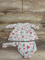 Floral baby dress set with matching bloomers and headband on wooden background