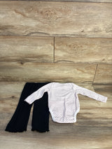 Flat-lay of Hello Kitty 2pc bodysuit and pants (12 months) showing white polka-dot bodysuit and black pants on wood floor